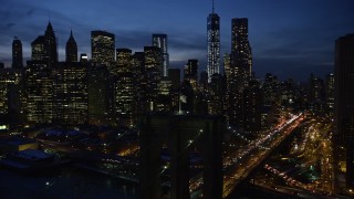 4.8K aerial stock footage approach and orbit Brooklyn Bridge, reveal Lower Manhattan skyscrapers in winter, New York City, twilight Aerial Stock Footage | AX66_0404E