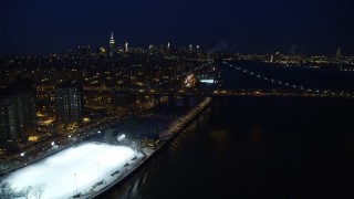 4.8K aerial stock footage of Williamsburg Bridge and Midtown Manhattan Skyline in winter, New York City, night Aerial Stock Footage | AX66_0409E