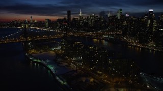 4.8K aerial stock footage fly over Queensboro Bridge toward Midtown Manhattan skyscrapers, New York City, night Aerial Stock Footage | AX66_0423E