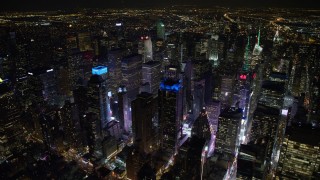 4.8K aerial stock footage view circling the bright lights of Times Square at night, Midtown Manhattan, New York City, New York Aerial Stock Footage | AX67_0031