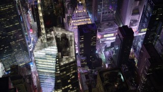 AX67_0034 - 4.8K aerial stock footage view of Times Square and Midtown skyscrapers at night, New York City, New York