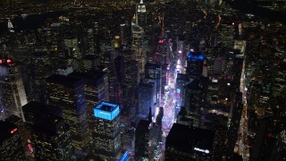 4.8K aerial stock footage view tilt from Times Square to reveal Empire State Building at night, Midtown Manhattan, New York City, New York Aerial Stock Footage | AX67_0036