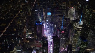 AX67_0040 - 4.8K aerial stock footage view flyby Times Square and skyscrapers at night, Midtown Manhattan, New York City, New York