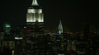 AX67_0050 - 4.8K aerial stock footage view flyby the Empire State Building and Chrysler Building at night, Midtown Manhattan, New York City, New York