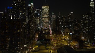 AX67_0054 - 4.8K aerial stock footage view of skyscrapers in the Hell's Kitchen area at night, Midtown Manhattan, New York City