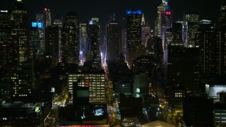 AX67_0055 - 4.8K aerial stock footage view of flying by Hell's Kitchen skyscrapers at night, Midtown Manhattan, New York City, New York