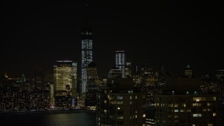 AX67_0069 - 4.8K aerial stock footage view of World Trade Center and Freedom Tower at night, New York