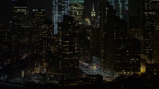 4.8K aerial stock footage view of flying by Lower Manhattan skyscrapers at night, New York Aerial Stock Footage | AX67_0076