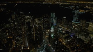 4.8K aerial stock footage view of flying by Lower Manhattan's towering skyscrapers at night, New York Aerial Stock Footage | AX67_0088