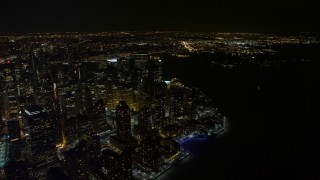 4.8K aerial stock footage view of orbiting skyscrapers by the river in Lower Manhattan at night, New York Aerial Stock Footage | AX67_0093