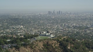 4.8K aerial stock footage pass by Griffith Observatory with Downtown Los Angeles in the distance, California Aerial Stock Footage | AX68_005