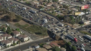 AX68_033 - 4.8K aerial stock footage flyby heavy freeway traffic on Interstate 5 through Boyle Heights, Los Angeles, California