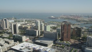 AX68_050 - 4.8K aerial stock footage tilt to reveal office buildings in Downtown Long Beach and the Queen Mary, California