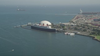 AX68_053 - 4.8K aerial stock footage of Queen Mary luxury liner docked by Long Beach Cruise Terminal, California