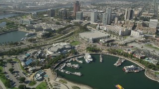 AX68_061 - 4.8K stock footage video of Aquarium of the Pacific, boats in Rainbow Harbor, and office buildings in Downtown Long Beach, California