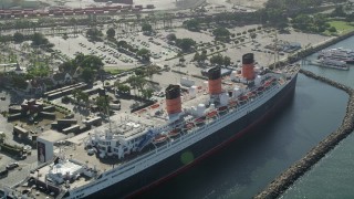 AX68_067 - 4.8K aerial stock footage flyby the RMS Queen Mary docked in Long Beach, California