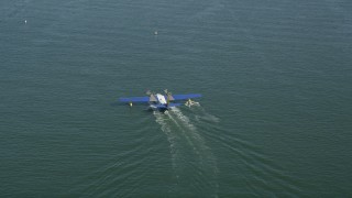 AX68_072 - 4.8K aerial stock footage of tracking a seaplane on San Pedro Bay, Long Beach, California