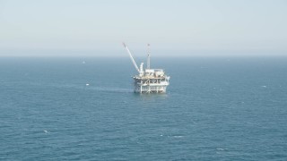 4.8K aerial stock footage tilt to reveal and approach an offshore oil platform near Long Beach, California Aerial Stock Footage | AX68_088