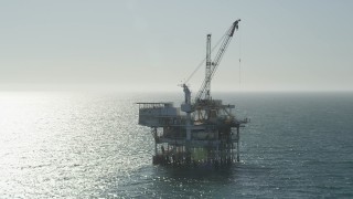 4.8K aerial stock footage orbit an oceanic oil drilling platform near Long Beach, California Aerial Stock Footage | AX68_092