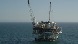 4.8K aerial stock footage of an orbit of an oceanic oil derrick near Long Beach, California Aerial Stock Footage | AX68_095