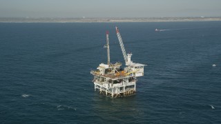 4.8K aerial stock footage of an orbit of an oceanic oil platform near the California Coast, Long Beach Aerial Stock Footage | AX68_098