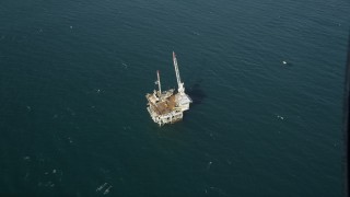 4.8K aerial stock footage of a bird's eye of an oceanic oil platform near Long Beach, off the California Coast Aerial Stock Footage | AX68_104