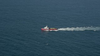 AX68_110 - 4.8K aerial stock footage of tracking a boat sailing across San Pedro Bay, Long Beach, California