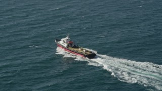 AX68_111 - 4.8K aerial stock footage of tracking a boat cruising across San Pedro Bay in Long Beach, California