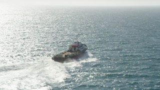 AX68_112 - 4.8K aerial stock footage of a red and white boat sailing across San Pedro Bay in Long Beach, California