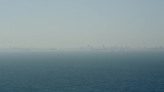 AX68_115 - 4.8K aerial stock footage of a seaplane flying across San Pedro Bay toward Downtown Long Beach, California