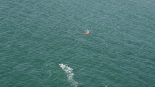 AX68_118 - 4.8K aerial stock footage track a kite surfer in San Pedro Bay, Long Beach, California