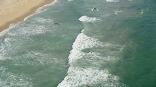 4.8K aerial stock footage reverse view of a kite surfer in San Pedro Bay by the beach, Long Beach, California Aerial Stock Footage | AX68_120