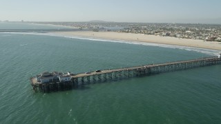 4.8K aerial stock footage flyby the end of Seal Beach Municipal Pier by beach and coastal neighborhoods in Seal Beach, California Aerial Stock Footage | AX68_124