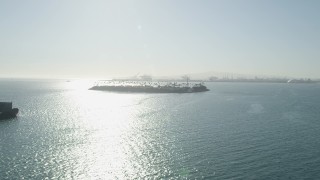 AX68_129 - 4.8K aerial stock footage approach and flyby Island Freeman oil drilling island in San Pedro Bay, Long Beach, California