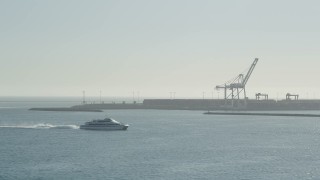 AX68_132 - 4.8K aerial stock footage of a ferry cruising across San Pedro Bay in Long Beach, California