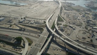 AX68_139 - 4.8K aerial stock footage follow I-710 with light traffic through Port of Long Beach, California