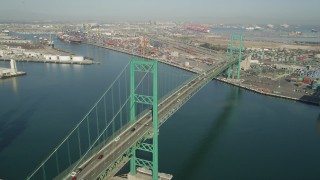 4.8K aerial stock footage approach the Vincent Thomas Bridge at the Port of Los Angeles, California and tilt to traffic Aerial Stock Footage | AX68_156