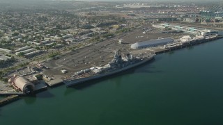 AX68_160 - 4.8K aerial stock footage reverse view of the USS Iowa and the Port of Los Angeles, California