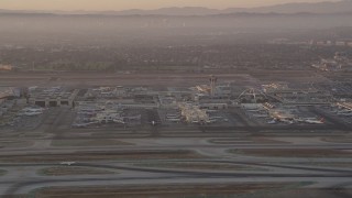 4.8K aerial stock footage of terminals and control tower at LAX at sunset, Los Angeles, California Aerial Stock Footage | AX69_007