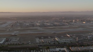 4.8K aerial stock footage of a view of runways, terminals and hangars at LAX at twilight, Los Angeles, California Aerial Stock Footage | AX69_009