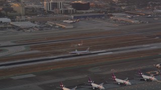 AX69_011 - 4.8K aerial stock footage track American Airlines passenger jet landing at LAX at sunset, Los Angeles, California