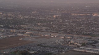 AX69_013 - 4.8K aerial stock footage of tracking an airliner approaching LAX at sunset for a landing, Los Angeles, California