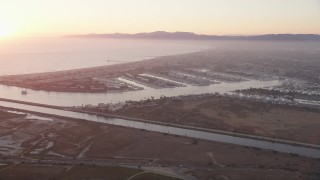 AX69_019 - 4.8K aerial stock footage of sunset at Marina Del Rey coastal neighborhoods, California