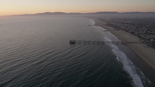 AX69_024 - 4.8K aerial stock footage approach the Venice Fishing Pier on the coast at sunset, California