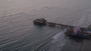 AX69_033 - 4.8K aerial stock footage approach and the end of Santa Monica Pier at twilight, California