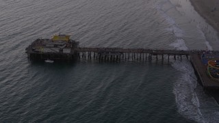 4.8K aerial stock footage flyby end of Santa Monica Pier at twilight, California Aerial Stock Footage | AX69_034