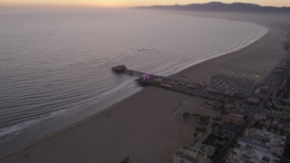 4.8K aerial stock footage fly over the beach and by the end of Santa Monica Pier at twilight, California Aerial Stock Footage | AX69_041