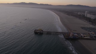 4.8K aerial stock footage of the end of Santa Monica Pier, Pacific Wheel, and the beach at twilight, California Aerial Stock Footage | AX69_042