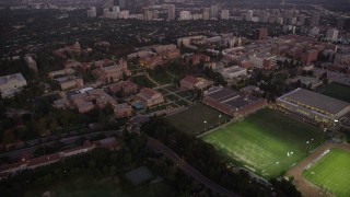 AX69_057 - 4.8K aerial stock footage approach campus buildings around Wilson Plaza at College at twilight in Westwood, California