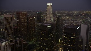 4.8K aerial stock footage fly over Paul Hastings Tower to approach US Bank Tower in Downtown Los Angeles, California at night Aerial Stock Footage | AX69_082